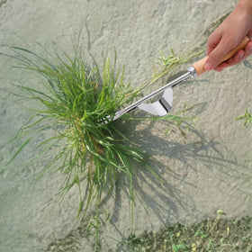 Theuzi lawn edger and driveway crack sickle reaches between pavers