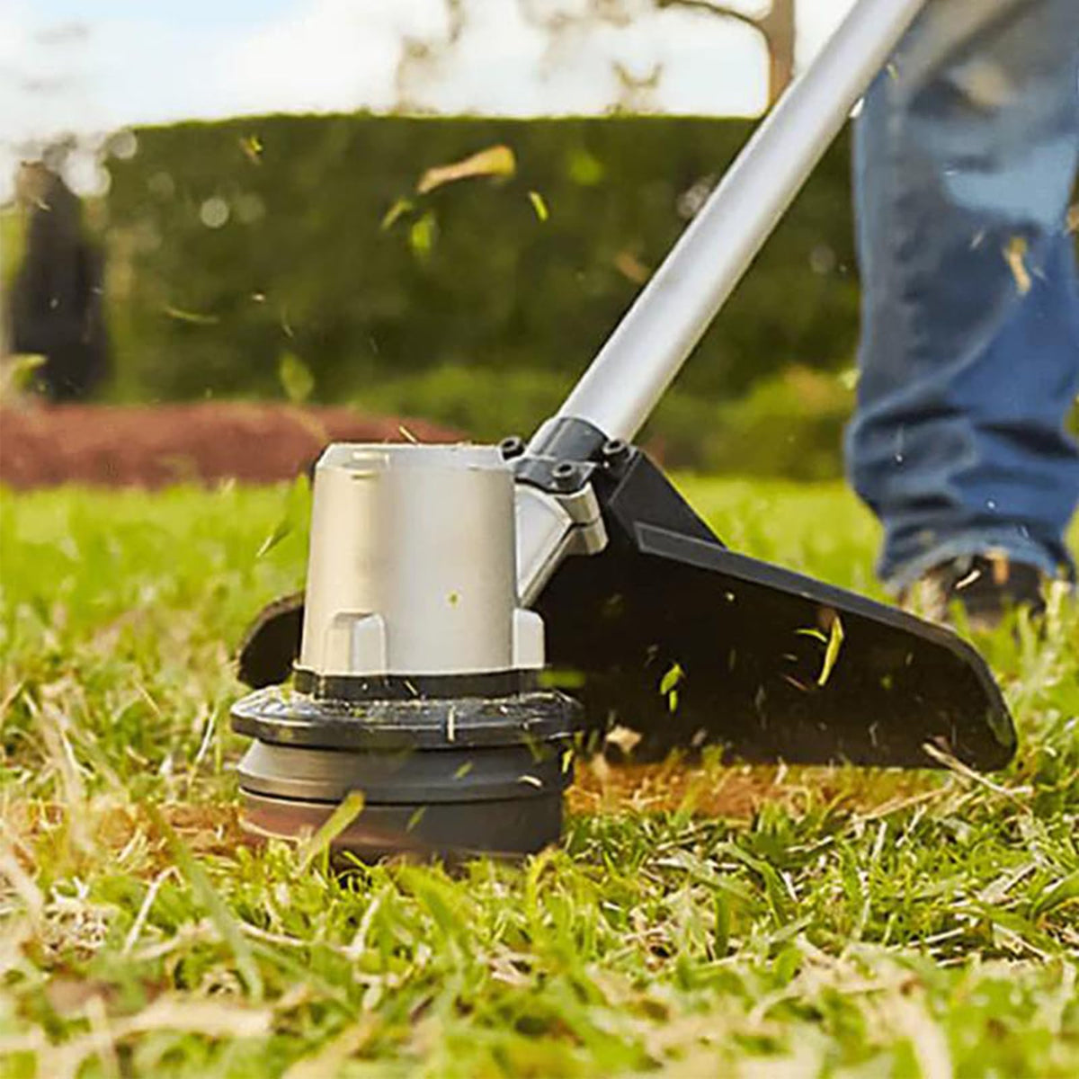 THTEN AH1300 trimmer head in use improves compatibility with popular trimmers.