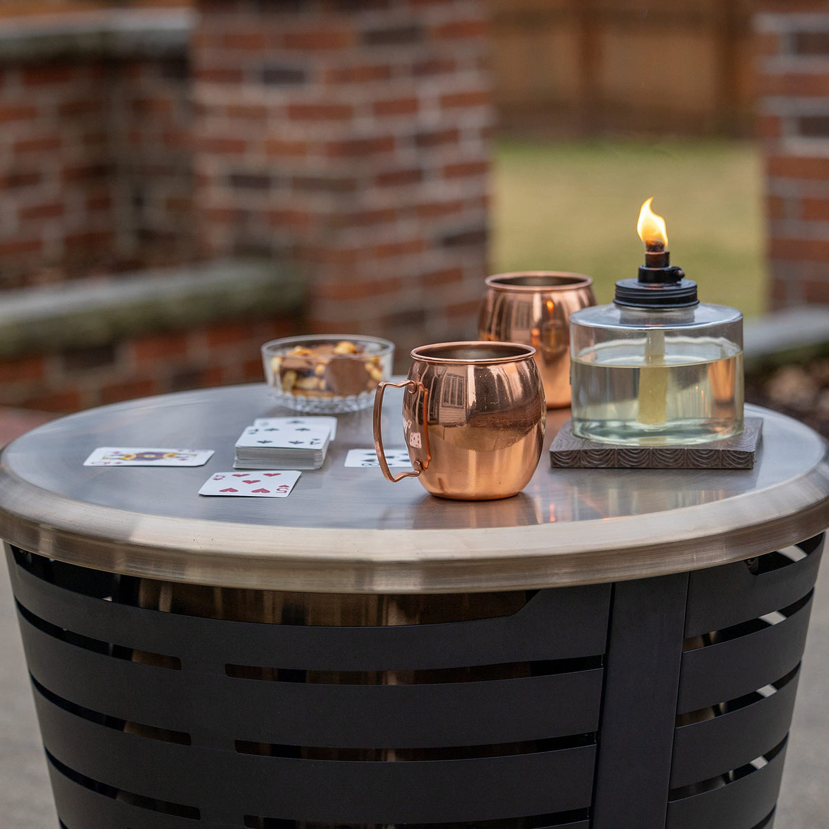 TIKI Celebration fire pit tabletop lid adds a stylish gold look for table-ready moments.