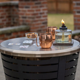 TIKI Celebration fire pit tabletop lid adds a stylish gold look for table-ready moments.