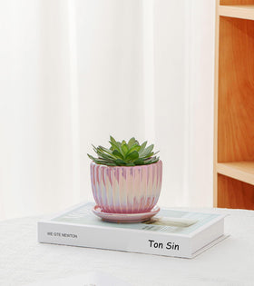 Closeup of Ton Sin glaze on ceramic pot with pink gold finish.