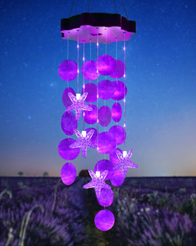 Toodour solar wind chimes with seashells glow purple for outdoor décor at night.