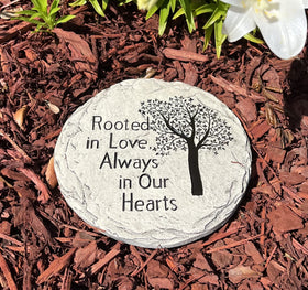 Top Brass memorial stone beside a rose bed gives a lasting garden tribute