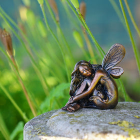 Top Collection Miniature Garden Fairy Figure shown among moss and pebbles for cozy indoor decor.