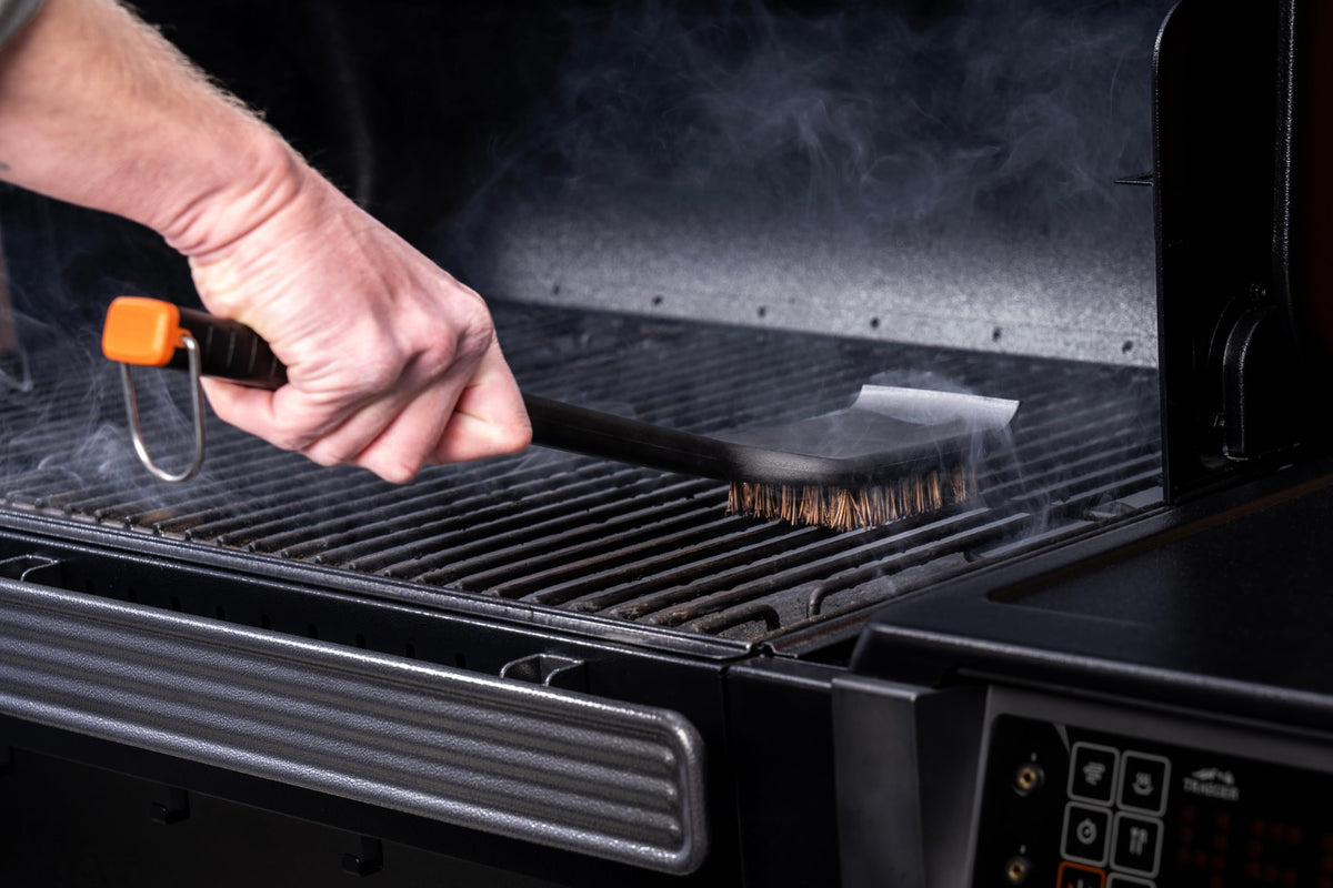 Traeger brush used on all-grates and flat-top compatibility across Traeger surfaces.
