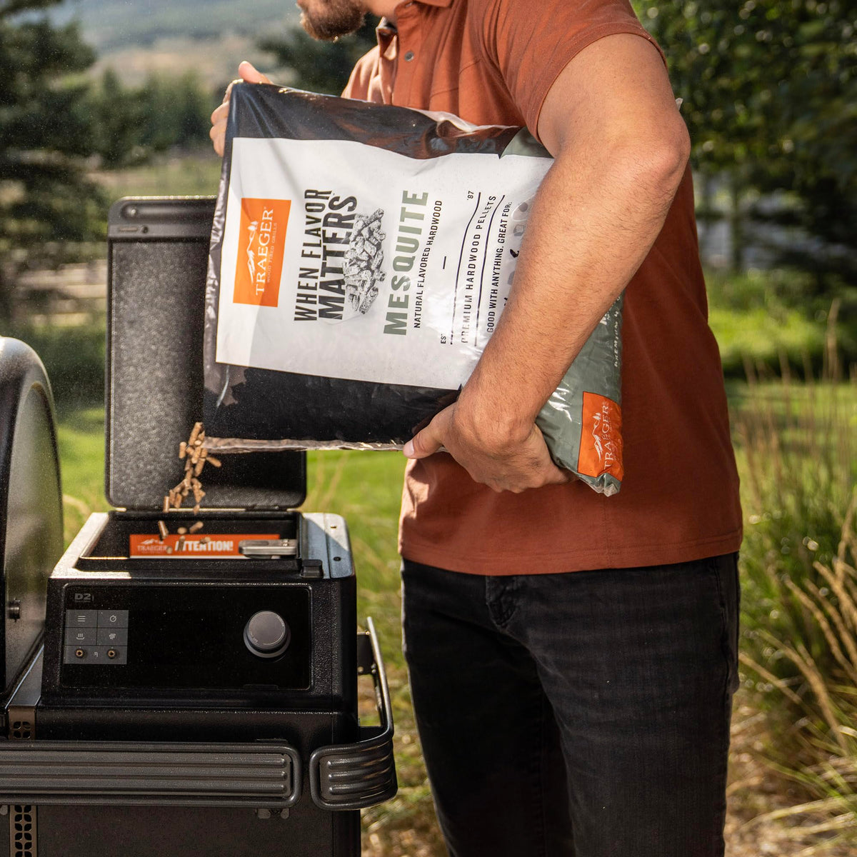 Grill in action with Traeger Mesquite smoke enhancing outdoor cooking.
