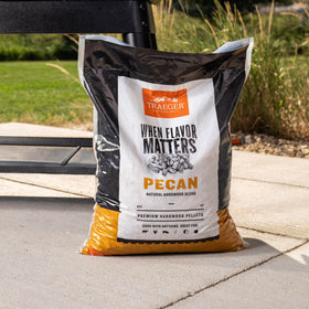 Traeger Pecan pellets on grill illustrate versatile cooking with nutty aroma.