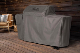 Traeger Woodridge Elite cover all-weather guards against wind and snow, keeping surfaces clean.