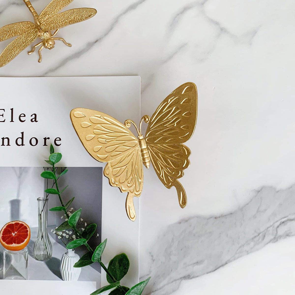 Tricune gold butterfly sculpture placed in garden for decor