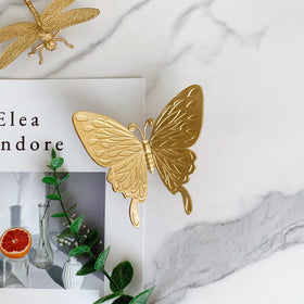 Tricune gold butterfly sculpture placed in garden for decor