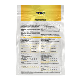 True Organic Citrus & Avocado Food granules scattered on soil indicate easy feeding.