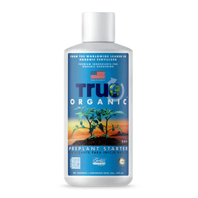 True Organic Liquid Preplant Starter bottle on a garden table for seedling growth