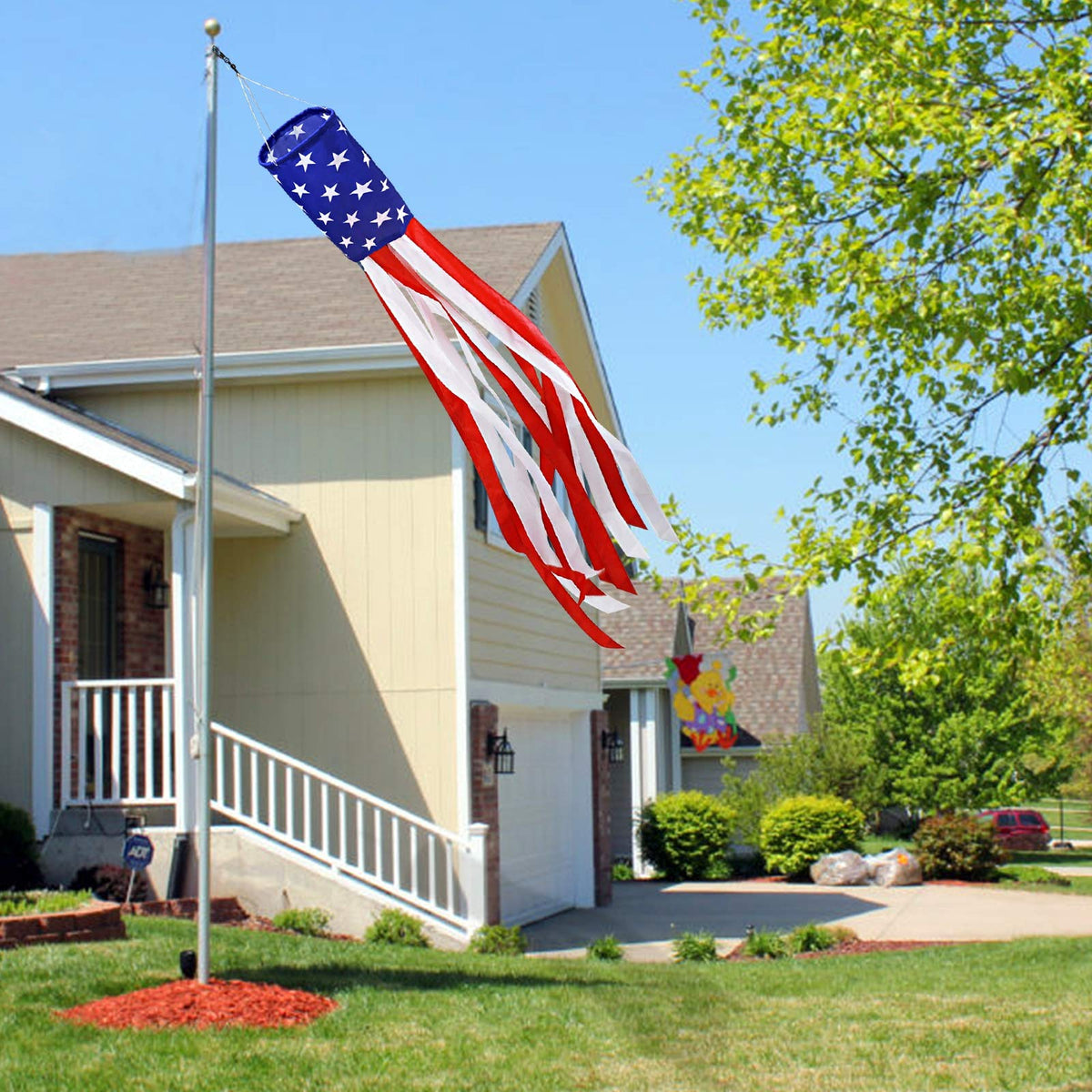 Turnmeon windsock with red white blue tails enhances curb appeal.