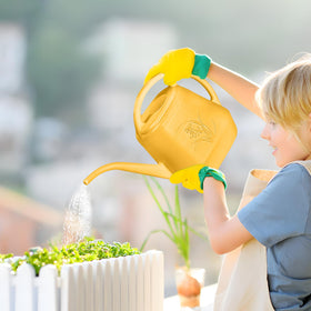 UFANME half-gallon orange watering can in a garden setting