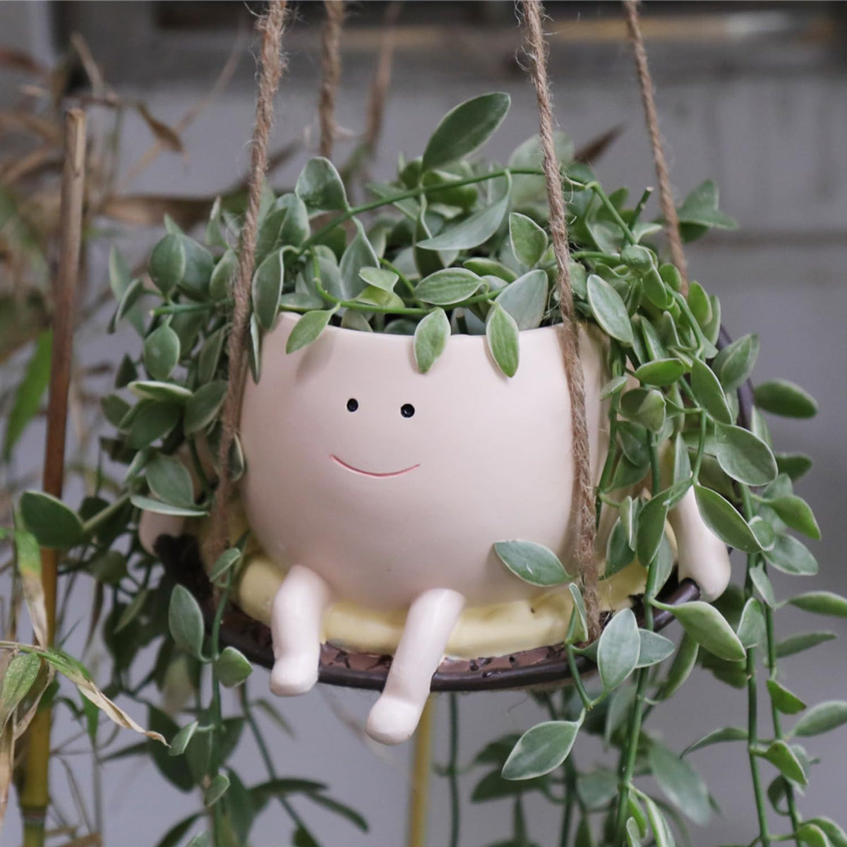 UMESONG hanging swing planter with a smiling face for cheerful indoor decor.