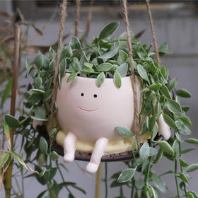 UMESONG hanging swing planter with a smiling face for cheerful indoor decor.
