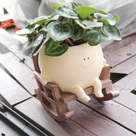 UMESONG Smily Face Planter in rocking chair close-up for lively indoor decor.
