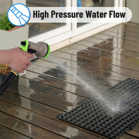 50-foot UNCO hose extended across a garden bed for broad coverage