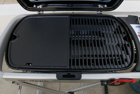 Uniflasy cast iron griddle half-coverage on Weber Traveler expands cooking space