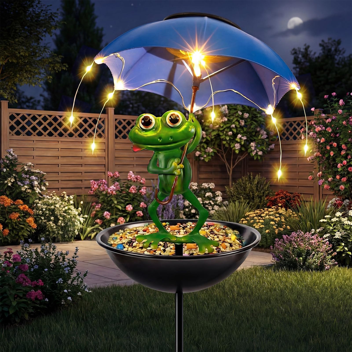 Vbioa Solar Frog Bird Feeder with umbrella light brightens the garden at night.