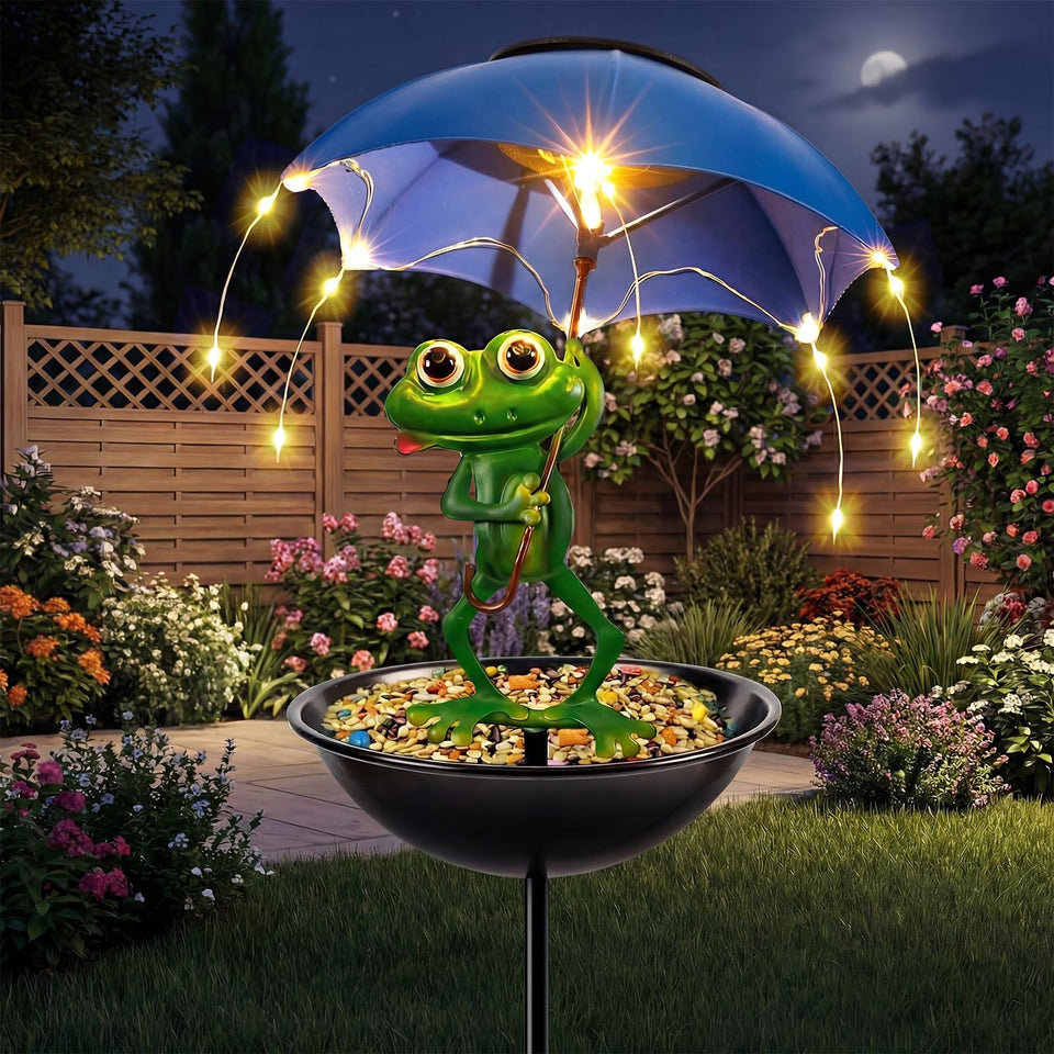 Vbioa Solar Frog Bird Feeder with umbrella light brightens the garden at night.