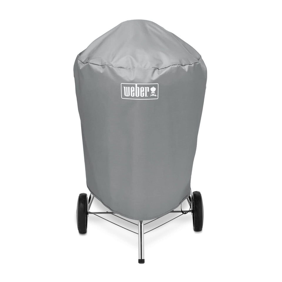 Weber 22-inch charcoal kettle cover, front view, secure straps for windy days.