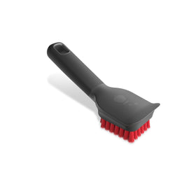 Weber Cool Clean Scraper Brush on a grill grate for safe, scratch-free cleaning.
