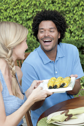 Weber corn pick set on grill demonstrates safe handling during hot corn.