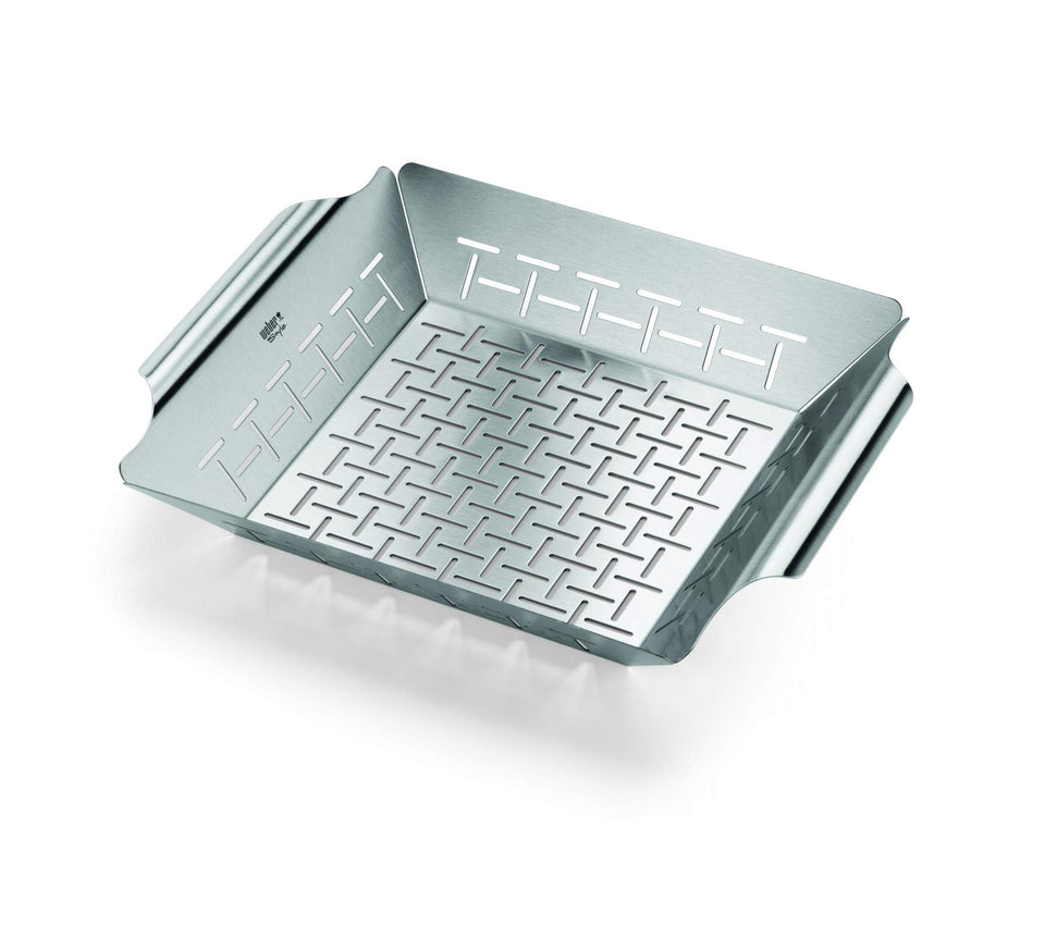 Weber Deluxe grilling basket with vegetables on grill for even cooking.