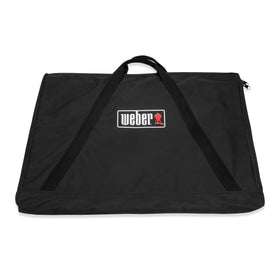 Weber full-size griddle storage bag shielding from rain and dust.