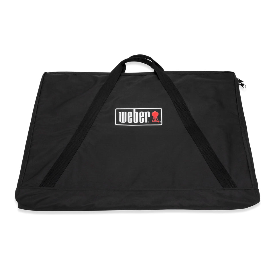 Weber full-size griddle storage bag shielding from rain and dust.