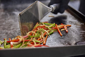 Weber Griddle Scraper removes grease after cooking on the griddle