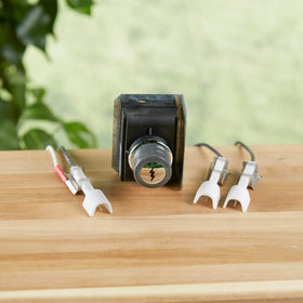 Installation scene of Weber igniter kit on Genesis front panel