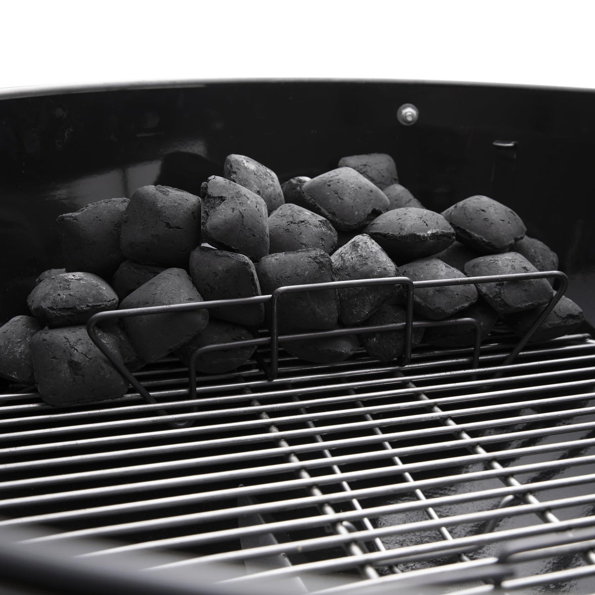 Charcoal rails organize fuel for direct searing and indirect cooking.
