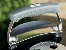 Weber Original Kettle 18-inch outdoor cooking scene suggests backyard gatherings.