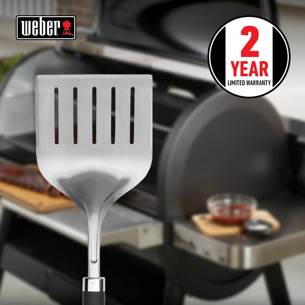 Weber Precision Grill Wide Spatula soft-touch handle shown for non-slip grip during grilling