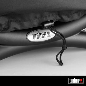 Weber Premium Bonnet Cover snugly fits Q1000-series grills for outdoor protection.