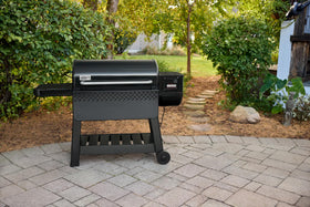 Weber Searwood 600 XL front table folded for compact storage beside grill