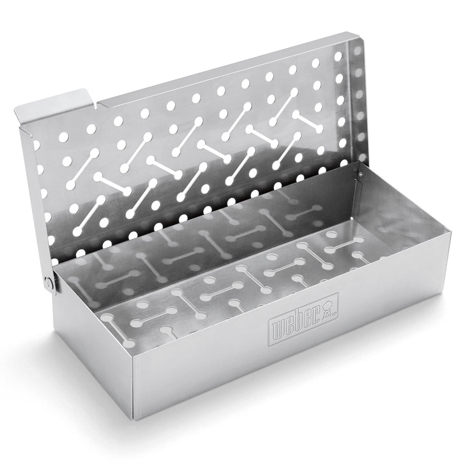 Weber smoker box under the grill delivering smoky flavor to grilled foods