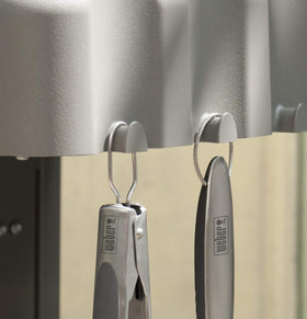 Weber spatula with ergonomic handle for comfortable cooking control.