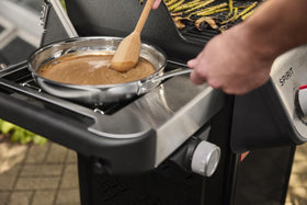 weber spirit e435 porcelain-enameled cast-iron grates retain heat evenly.