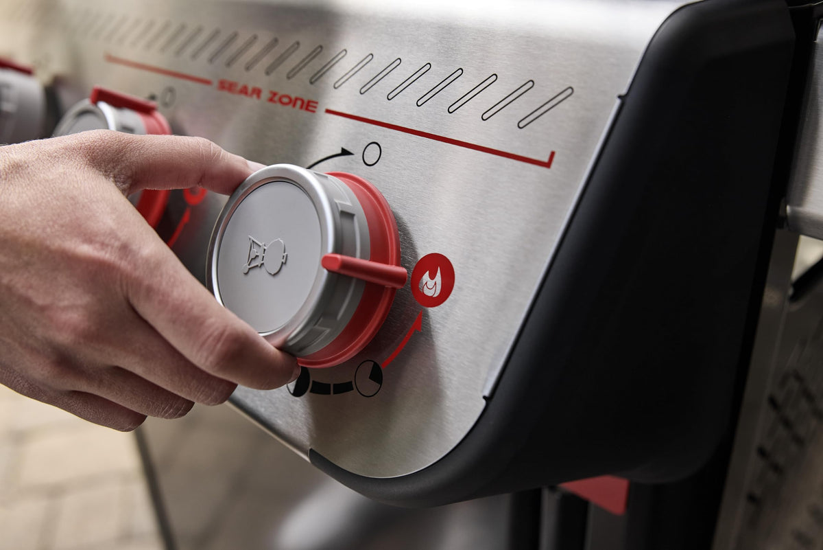 weber spirit e435 side burner adds extra space for sauces.