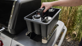 Weber Works Caddy with tray lid on grill setup shows portable prep station.