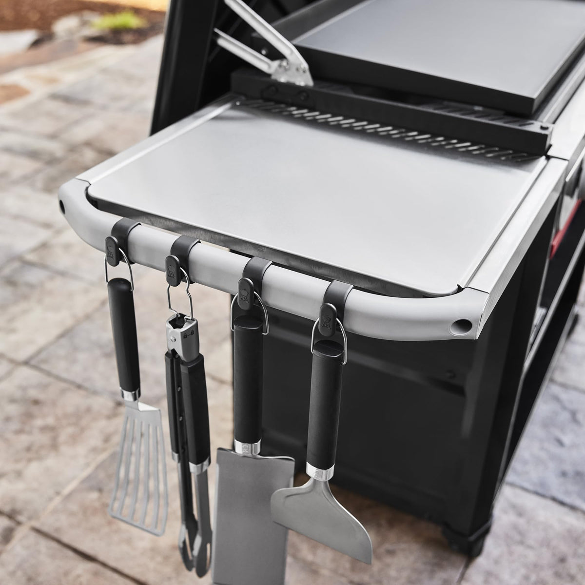 Weber Works rail-mounted system attaches easily to compatible Slate griddles.