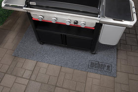 Weber XL Floor Protection Mat roll-up storage enables quick cleanup after cooking.