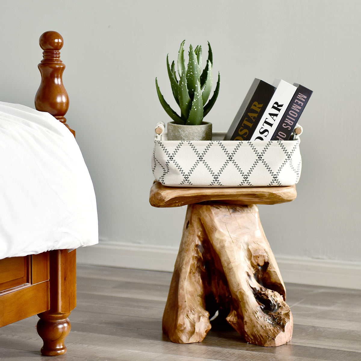 WELLAND cedar stump plant stand supporting a small indoor plant display.