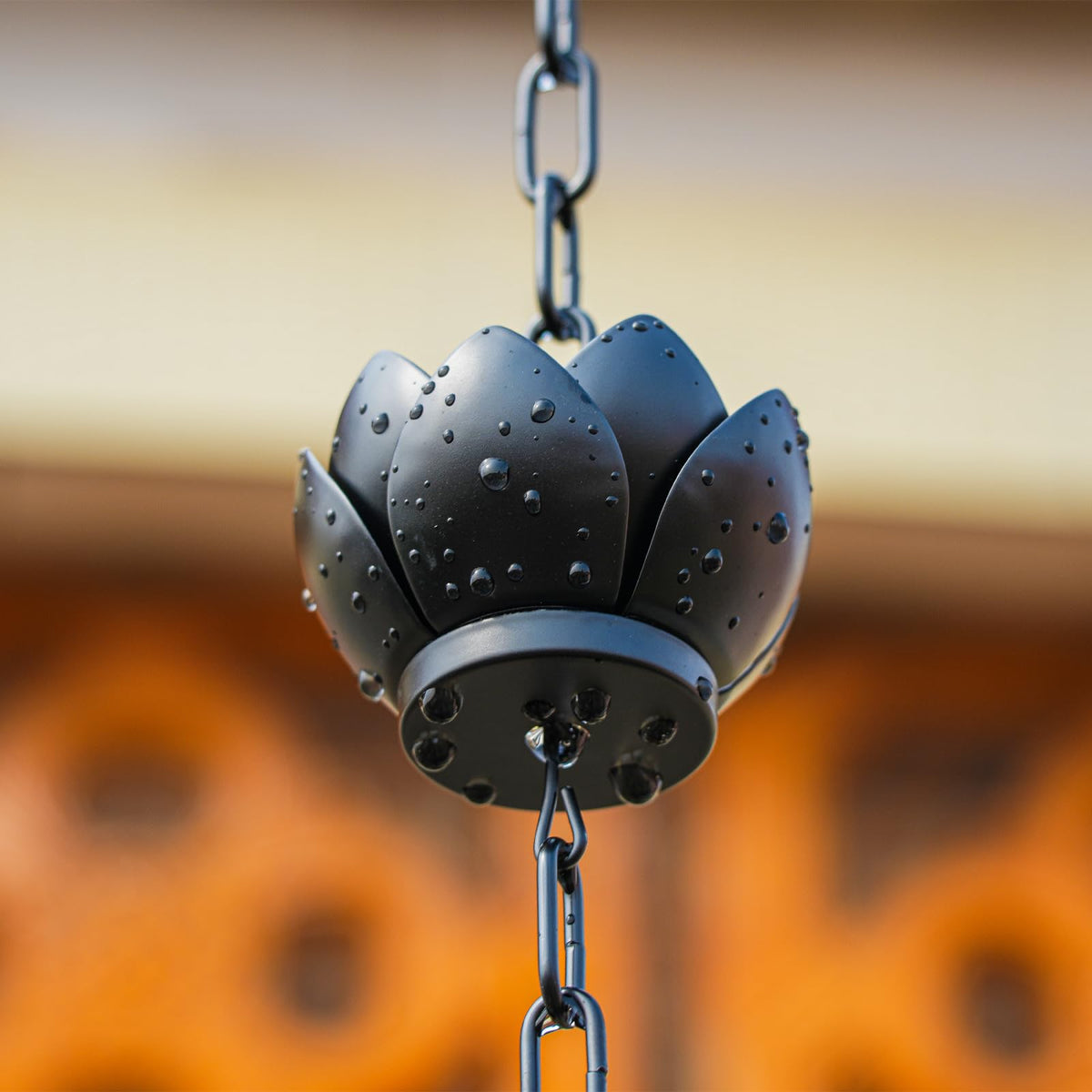 Wellrain rain chain in a garden patio setting enhances outdoor decor and ambiance.