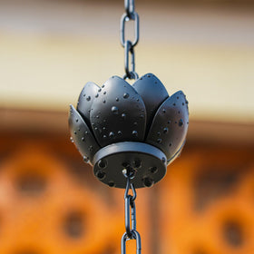 Wellrain rain chain in a garden patio setting enhances outdoor decor and ambiance.