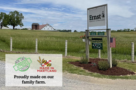 Wholesome Harvest goat feed on a farm setting with logo