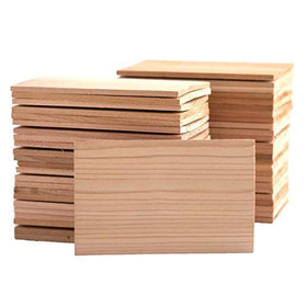 Wildwood Grilling bulk cedar planks on grill for restaurant prep.